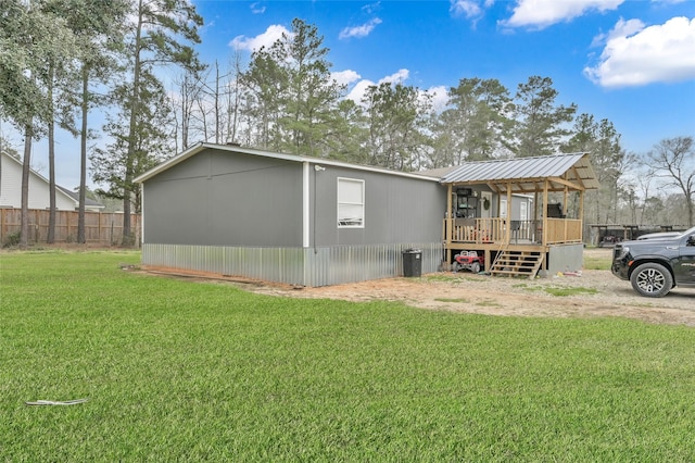 view of side of home featuring a yard and fence