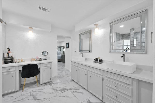 ensuite bathroom featuring a sink, visible vents, marble finish floor, and connected bathroom