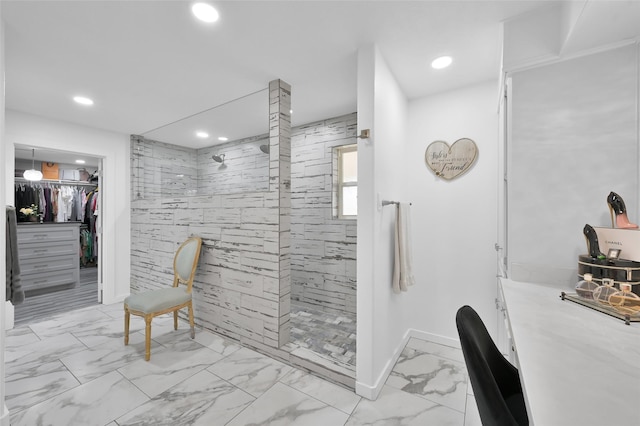 full bathroom with walk in shower, a walk in closet, marble finish floor, and recessed lighting