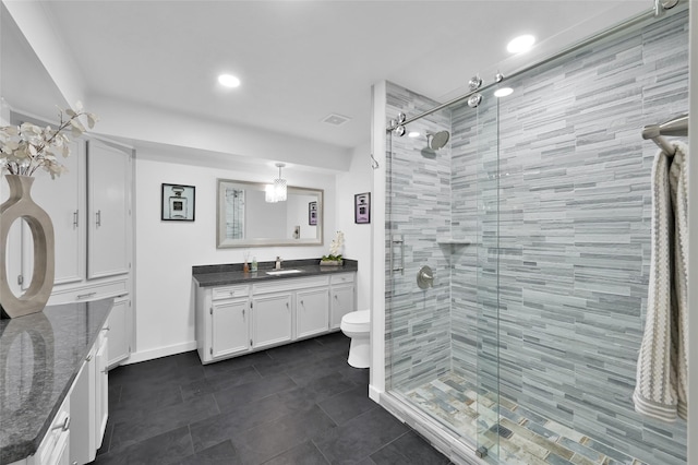 full bath featuring vanity, a shower stall, toilet, and visible vents