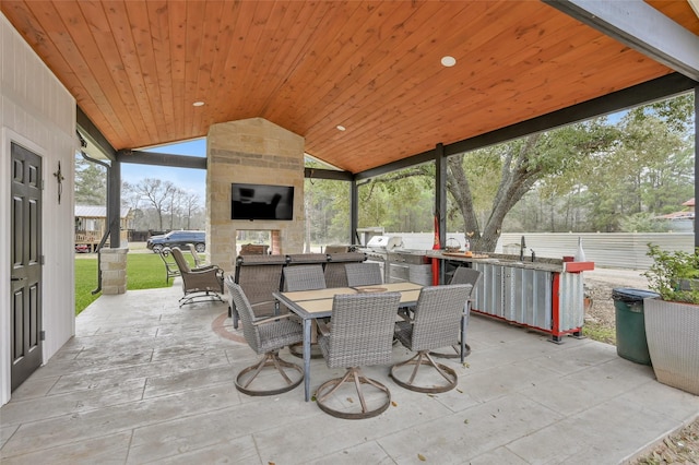 view of patio / terrace with outdoor dining space, a sink, and area for grilling