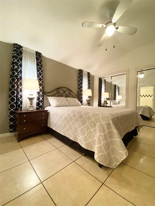 bedroom with vaulted ceiling, ceiling fan, and tile patterned floors