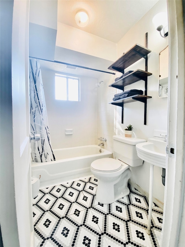 full bathroom with toilet, shower / bathtub combination with curtain, and tile patterned flooring