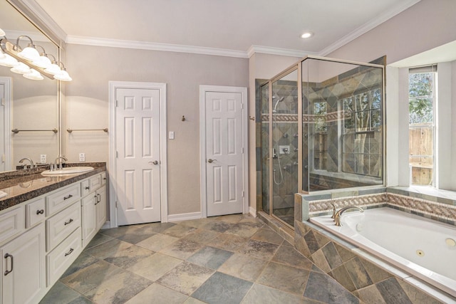 bathroom featuring crown molding, a stall shower, a sink, and a whirlpool tub