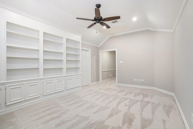 unfurnished room featuring light carpet, baseboards, visible vents, lofted ceiling, and ornamental molding