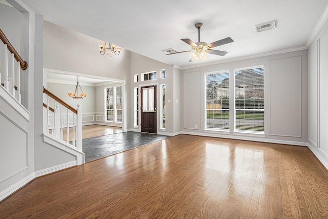 entrance foyer featuring a wealth of natural light, wood finished floors, visible vents, and stairs