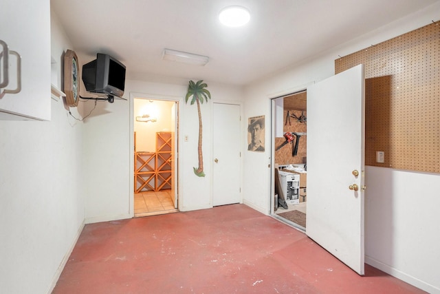 interior space with concrete floors and baseboards