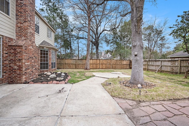 view of yard featuring a patio area and a fenced backyard