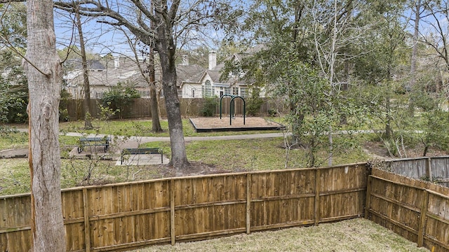 view of yard featuring a playground and a fenced backyard