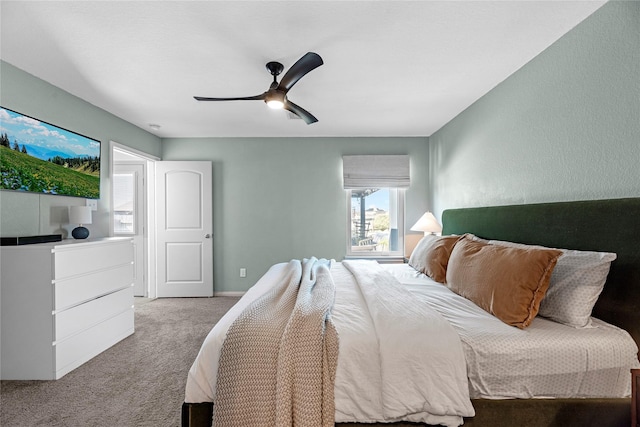 carpeted bedroom with baseboards and a ceiling fan