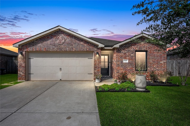 single story home featuring a garage, driveway, brick siding, and a front yard