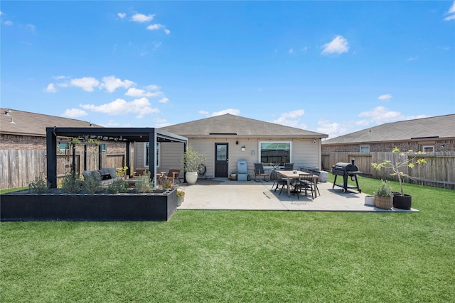 back of property with a patio area, a fenced backyard, and a lawn