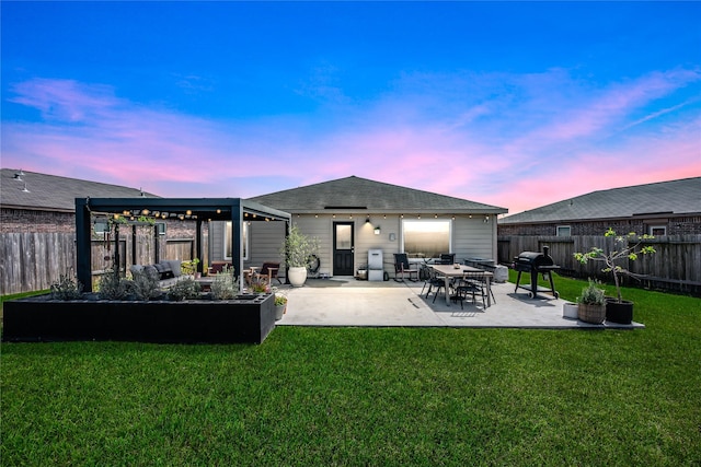 rear view of house with a patio area, a fenced backyard, and a lawn