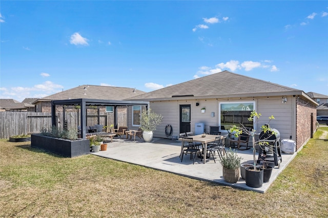 back of house with a yard, a patio area, fence, and a garden