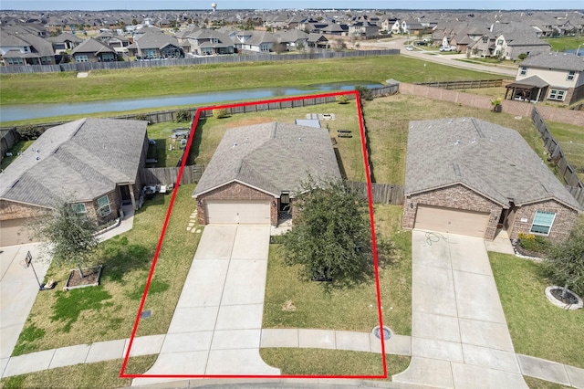 birds eye view of property featuring a water view and a residential view