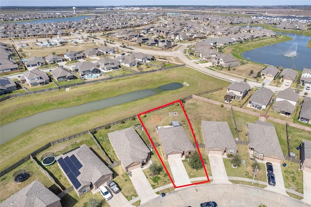 drone / aerial view featuring a residential view and a water view