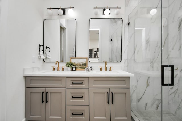 bathroom featuring a sink, a marble finish shower, and double vanity