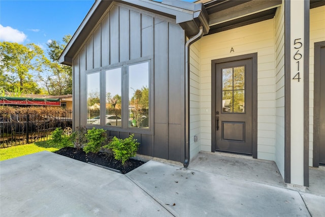 doorway to property featuring board and batten siding