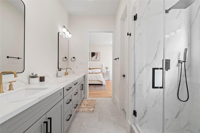 bathroom with a sink, ensuite bath, a marble finish shower, and double vanity