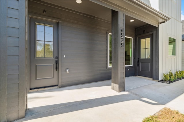 entrance to property featuring covered porch and board and batten siding