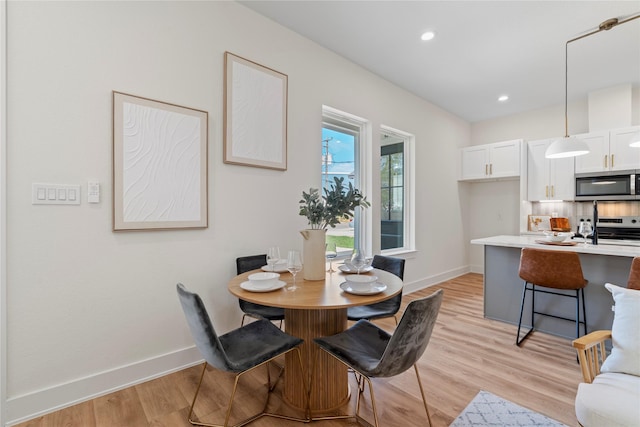 dining area featuring baseboards, recessed lighting, and light wood-style floors