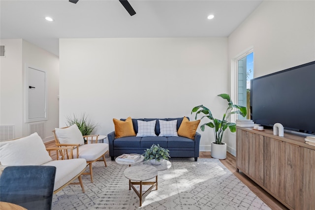 living area featuring recessed lighting, visible vents, light wood-style flooring, a ceiling fan, and baseboards