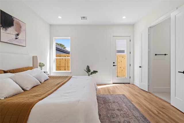 bedroom featuring baseboards, visible vents, wood finished floors, and recessed lighting