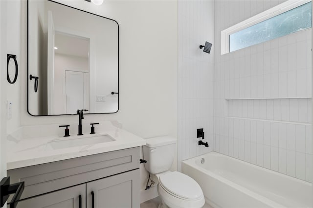 bathroom with shower / washtub combination, vanity, and toilet