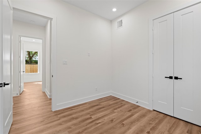 interior space featuring light wood-style floors, recessed lighting, visible vents, and baseboards