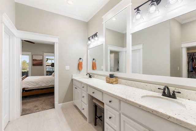 full bath featuring crown molding, a sink, baseboards, and double vanity