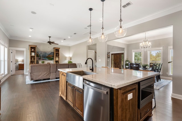 kitchen with stainless steel appliances, dark wood-type flooring, a sink, visible vents, and an island with sink