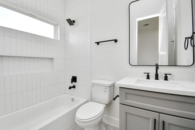 bathroom featuring toilet, visible vents, vanity, baseboards, and shower / washtub combination