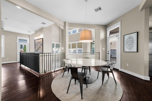 dining area featuring lofted ceiling with beams, hardwood / wood-style flooring, visible vents, and baseboards