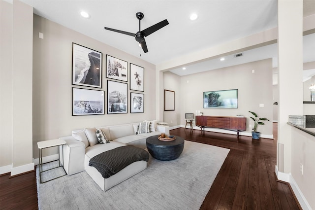 living room with ceiling fan, baseboards, and hardwood / wood-style floors