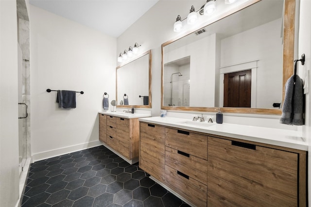 bathroom featuring tile patterned flooring, a sink, two vanities, visible vents, and a stall shower