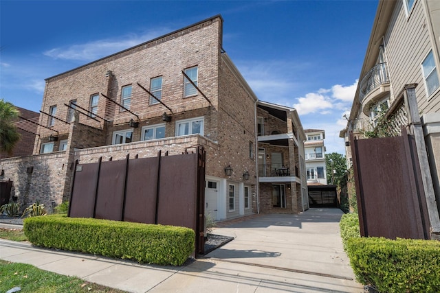 view of property with a garage and driveway