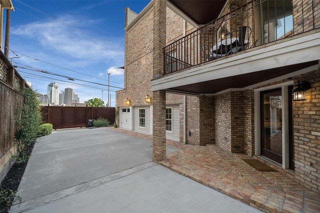 view of patio / terrace with a balcony and a fenced backyard