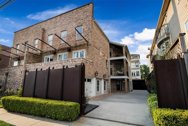 view of building exterior featuring a garage and fence