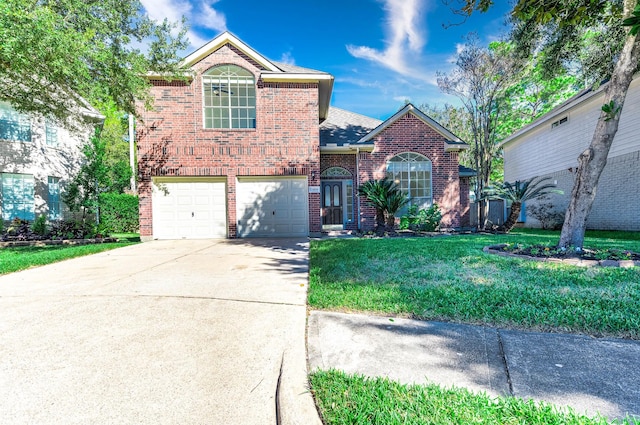 traditional-style home featuring driveway, a garage, a shingled roof, a front lawn, and brick siding