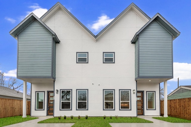 view of front of house featuring fence