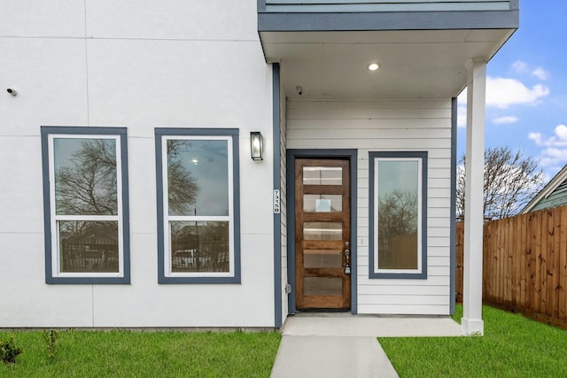 doorway to property featuring fence