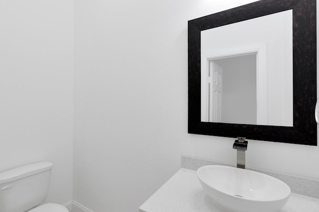 bathroom featuring toilet and a sink