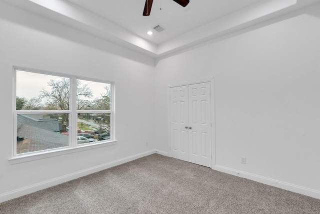 spare room with carpet, recessed lighting, visible vents, a ceiling fan, and baseboards