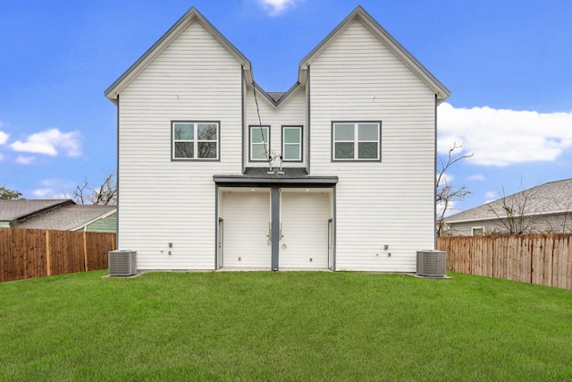 rear view of property with a fenced backyard, cooling unit, and a lawn