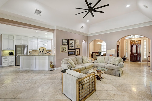 living area with arched walkways, visible vents, and light tile patterned flooring