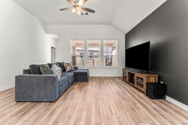 living area featuring lofted ceiling, visible vents, a ceiling fan, light wood-type flooring, and baseboards