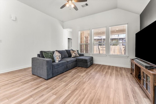 living area with lofted ceiling, visible vents, baseboards, a ceiling fan, and light wood finished floors