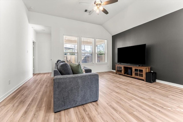 living room with light wood finished floors, a ceiling fan, visible vents, and baseboards