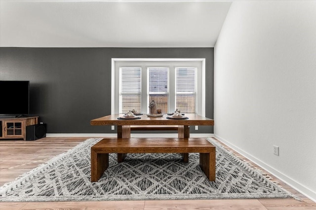 dining room featuring baseboards and wood finished floors