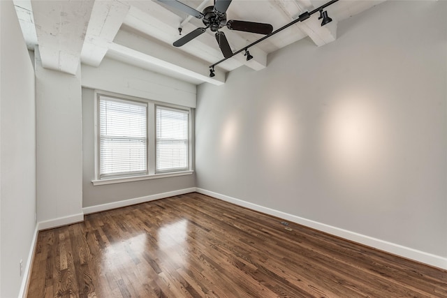 spare room with a ceiling fan, rail lighting, baseboards, and wood finished floors